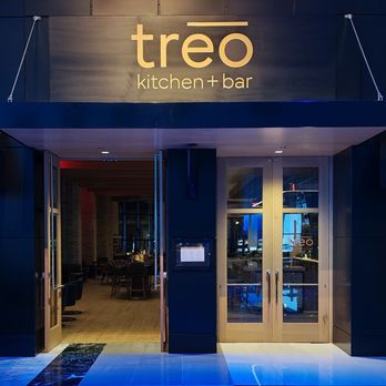 Entrance to treo kitchen + bar with glass doors and interior visible